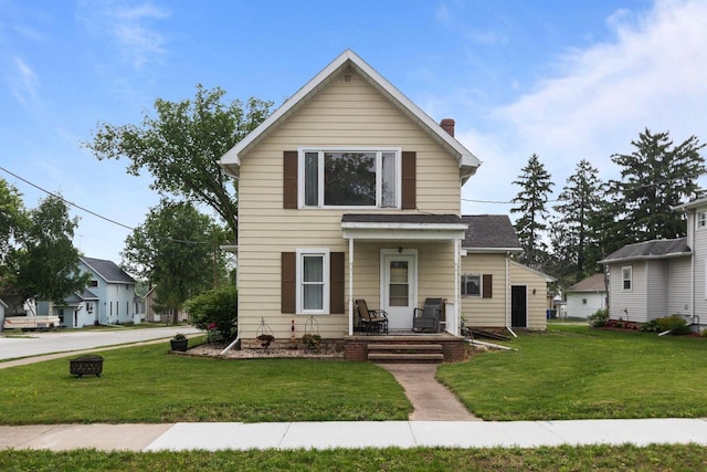 814 Quinney Ave, Kaukauna, WI 54130 - traditional home with a front lawn, a chimney, and covered porch