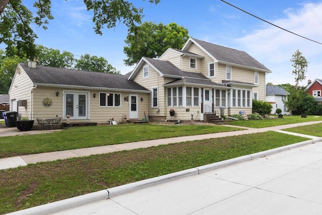 814 Quinney Ave, Kaukauna, WI 54130 - traditional-style home with french doors, entry steps, a front yard, a chimney, and a garage
