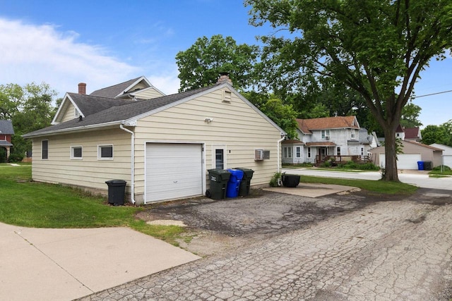 814 Quinney Ave, Kaukauna, WI 54130 - view of side of property with a chimney, roof with shingles, a garage, and a yard