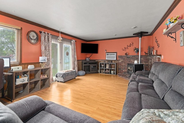 814 Quinney Ave, Kaukauna, WI 54130 - living room with crown molding, wood finished floors, a wainscoted wall, a wood stove, and a wall mounted air conditioner
