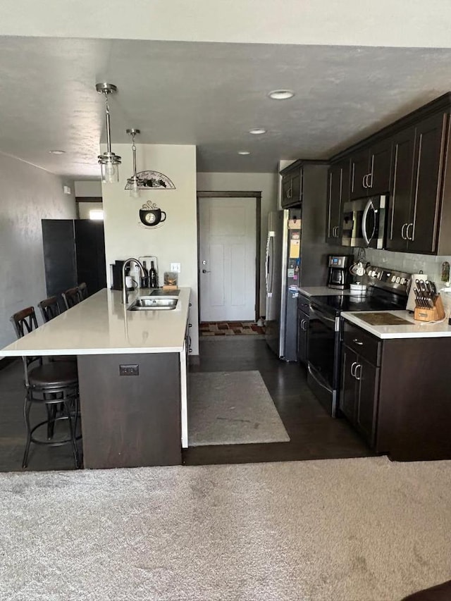 4842 N Marlo Way Unit 35, Appleton, WI 54913 - kitchen featuring appliances with stainless steel finishes, a kitchen breakfast bar, light countertops, a peninsula, and hanging light fixtures