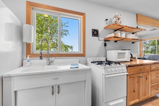9347 Musky Bay Ln, Harshaw, WI 95429 - kitchen featuring white appliances, open shelves, light countertops, and light wood-style flooring