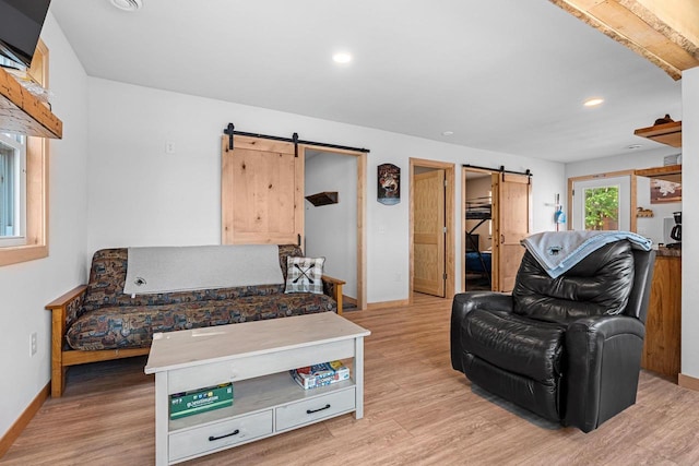9347 Musky Bay Ln, Harshaw, WI 95429 - living area with a barn door, light wood finished floors, and recessed lighting
