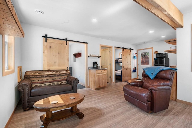 9347 Musky Bay Ln, Harshaw, WI 95429 - living area with a barn door, light wood-style floors, and recessed lighting