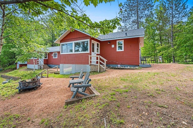 9347 Musky Bay Ln, Harshaw, WI 95429 - back of house featuring a fire pit, entry steps, and board and batten siding