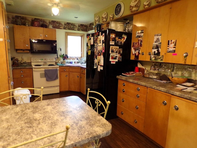 210 W S St, Loyal, WI 54446 - kitchen with black appliances, dark wood finished floors, brown cabinetry, a ceiling fan, and light countertops