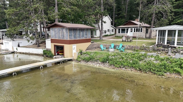 N2817 Rustic Dr, Clintonville, WI 54929 - back of house with a sunroom and a water view