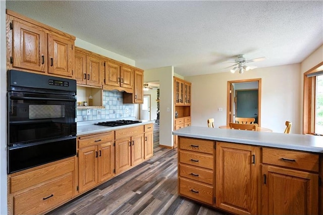 W5342 County Highway F, Trego, WI 54888 - kitchen featuring black appliances, a warming drawer, a ceiling fan, dark wood-style floors, and a textured ceiling
