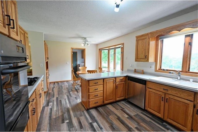 W5342 County Highway F, Trego, WI 54888 - kitchen featuring black appliances, a warming drawer, a peninsula, a textured ceiling, and dark wood finished floors