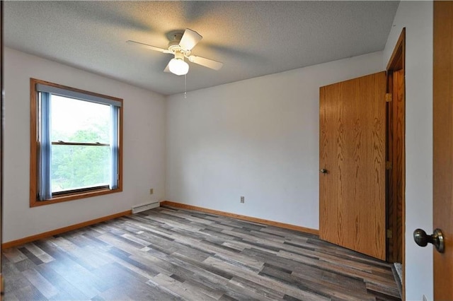 W5342 County Highway F, Trego, WI 54888 - spare room with wood finished floors, ceiling fan, a baseboard radiator, and a textured ceiling