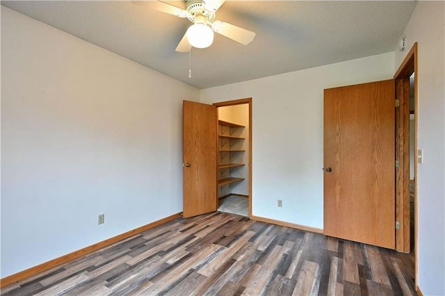W5342 County Highway F, Trego, WI 54888 - unfurnished bedroom featuring wood finished floors, a closet, and a ceiling fan