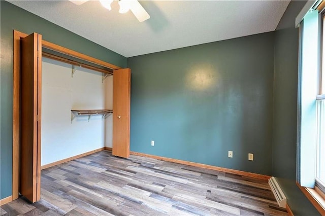 W5342 County Highway F, Trego, WI 54888 - unfurnished bedroom with wood finished floors, ceiling fan, and a closet