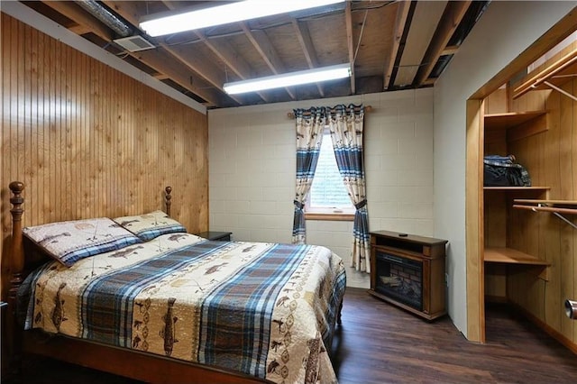 W5342 County Highway F, Trego, WI 54888 - bedroom featuring wood finished floors, wooden walls, and concrete block wall