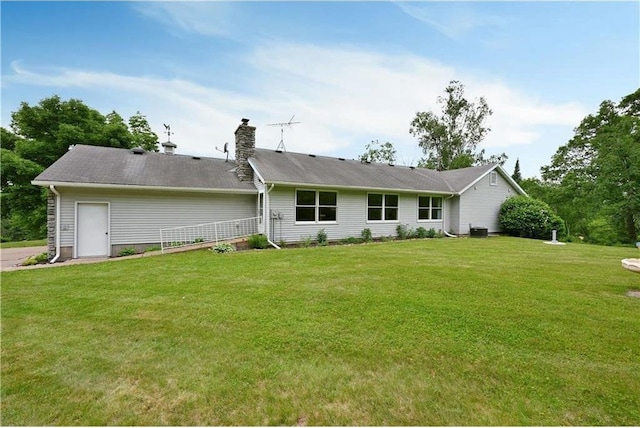 W5342 County Highway F, Trego, WI 54888 - rear view of property featuring a lawn and a chimney