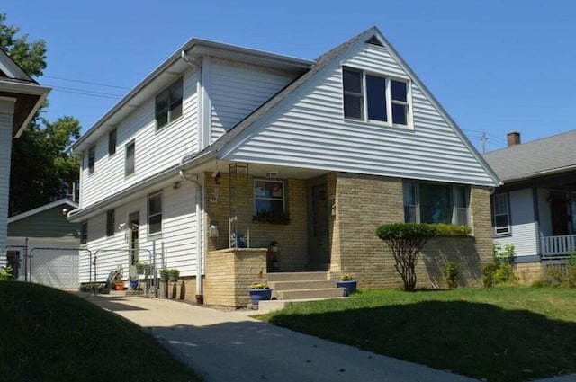 2759 N 57th St Unit 2761, Milwaukee, WI 53210 - bungalow-style home with brick siding, a porch, a garage, and a front yard