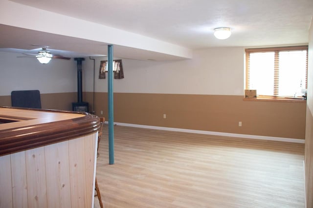 4303 E Milwaukee St Unit B, Janesville, WI 53546 - below grade area with a wood stove and light wood-style floors