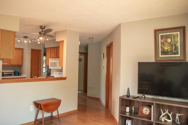 4303 E Milwaukee St Unit B, Janesville, WI 53546 - living room featuring a ceiling fan and light wood-type flooring