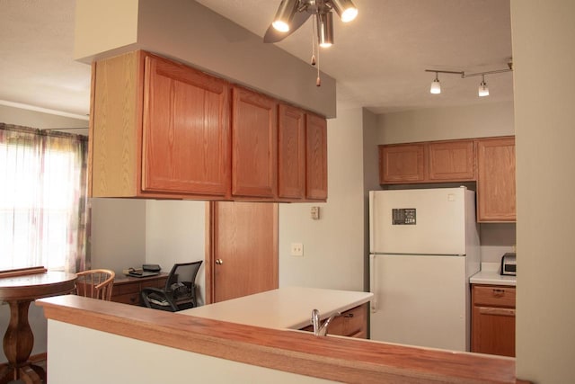 4303 E Milwaukee St Unit B, Janesville, WI 53546 - kitchen with freestanding refrigerator, a ceiling fan, light countertops, and a desk