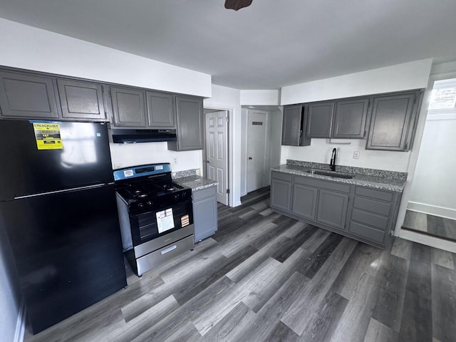 6337 13th Ave, Kenosha, WI 53143 - kitchen featuring freestanding refrigerator, stainless steel gas range, dark wood-type flooring, range hood, and gray cabinets