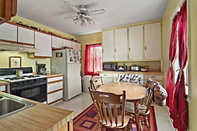 7732 15th Ave, Kenosha, WI 53143 - kitchen featuring white appliances, under cabinet range hood, light countertops, a ceiling fan, and white cabinets