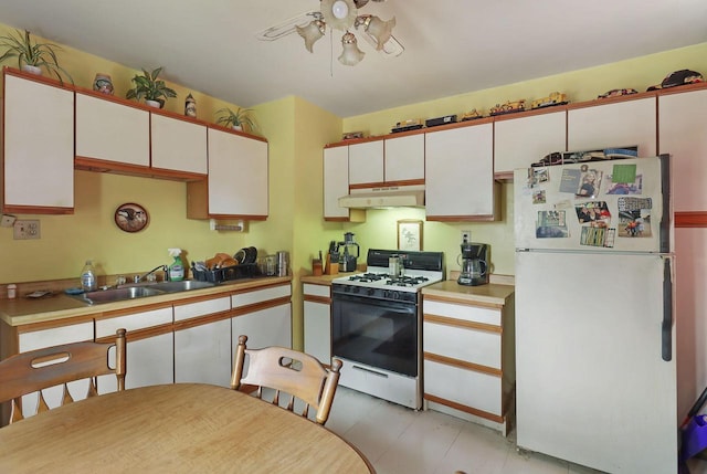 7732 15th Ave, Kenosha, WI 53143 - kitchen featuring white appliances, under cabinet range hood, white cabinetry, and light countertops
