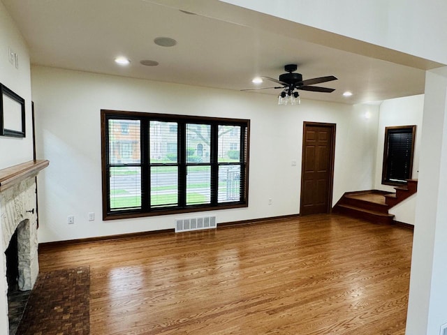 3441 N 55th St, Milwaukee, WI 53216 - unfurnished living room with a fireplace, wood finished floors, stairs, recessed lighting, and a ceiling fan