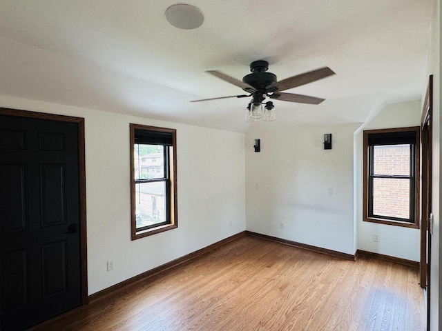3441 N 55th St, Milwaukee, WI 53216 - empty room with light wood-style flooring, a ceiling fan, and vaulted ceiling