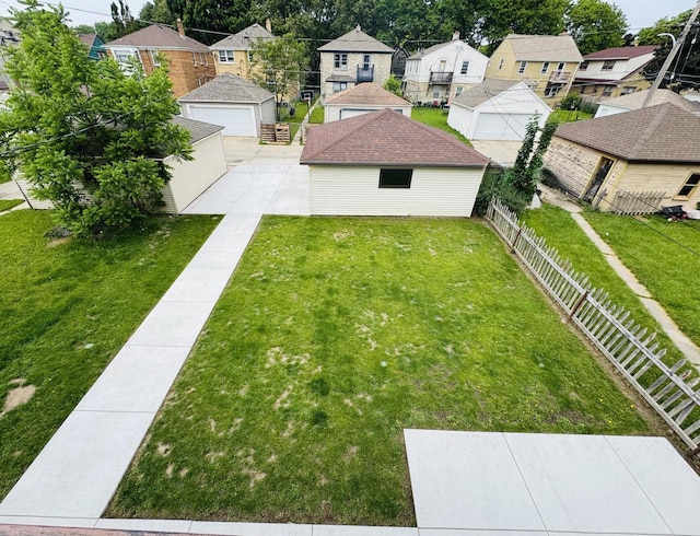 3441 N 55th St, Milwaukee, WI 53216 - fenced backyard featuring a garage, a residential view, and an outdoor structure