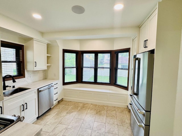 3441 N 55th St, Milwaukee, WI 53216 - kitchen with stainless steel appliances, open shelves, recessed lighting, white cabinets, and light countertops