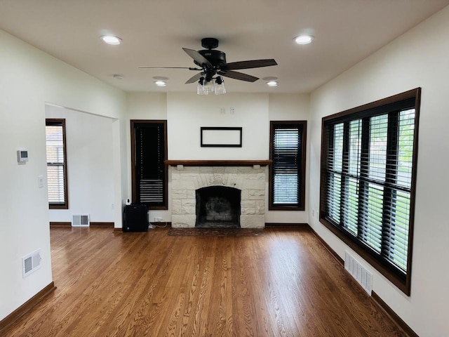 3441 N 55th St, Milwaukee, WI 53216 - unfurnished living room featuring healthy amount of natural light, recessed lighting, ceiling fan, a stone fireplace, and wood finished floors