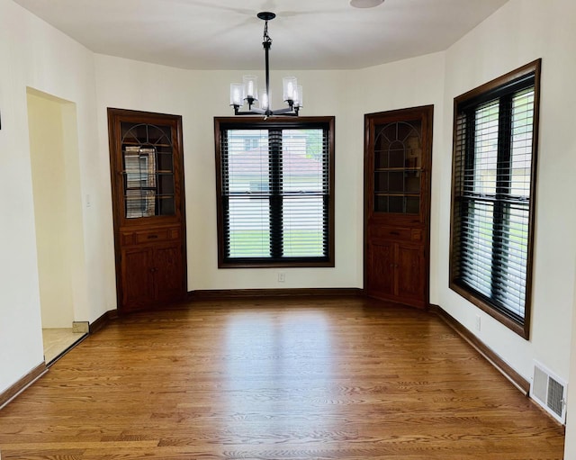 3441 N 55th St, Milwaukee, WI 53216 - unfurnished dining area featuring a chandelier and wood finished floors