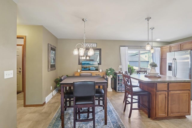 7042 Littlemore Dr, Madison, WI 53718 - dining space with a chandelier and baseboards