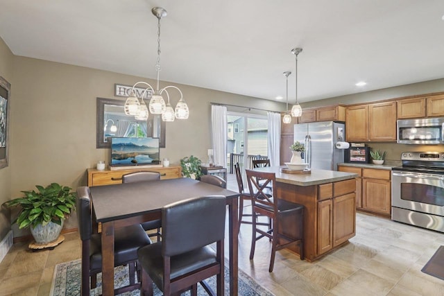 7042 Littlemore Dr, Madison, WI 53718 - kitchen featuring stainless steel appliances, a center island, a chandelier, hanging light fixtures, and recessed lighting