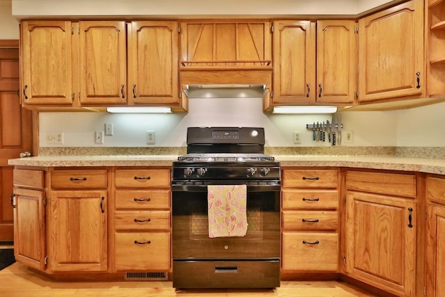 2413 Ravenswood Rd, Madison, WI 53711 - kitchen featuring black gas stove, light countertops, open shelves, and light wood-type flooring