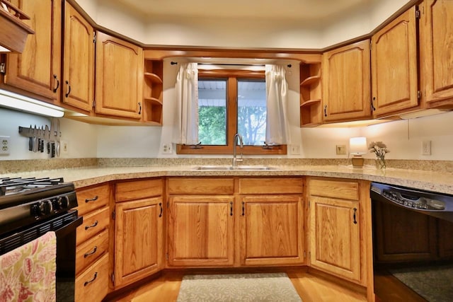2413 Ravenswood Rd, Madison, WI 53711 - kitchen featuring black appliances, open shelves, light countertops, and light wood-type flooring
