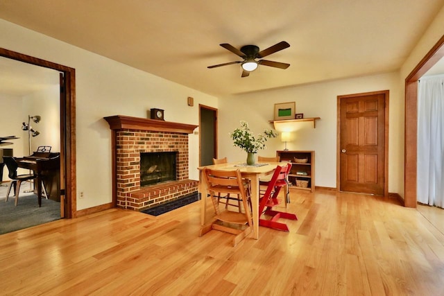 2413 Ravenswood Rd, Madison, WI 53711 - dining room featuring ceiling fan, light wood-style floors, and a fireplace