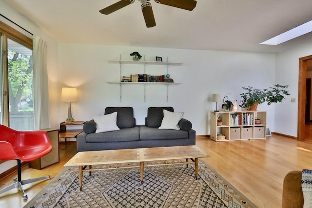 2413 Ravenswood Rd, Madison, WI 53711 - living room with wood finished floors, a ceiling fan, and a skylight