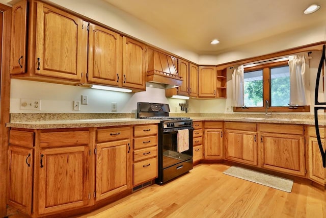2413 Ravenswood Rd, Madison, WI 53711 - kitchen featuring gas stove, brown cabinetry, light wood-type flooring, light countertops, and recessed lighting