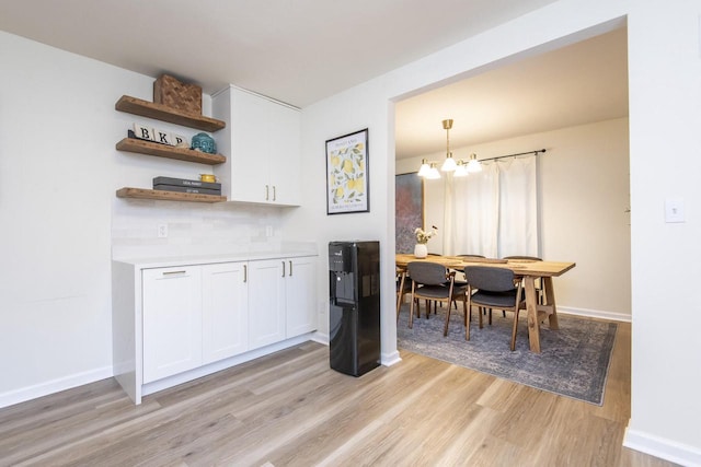 8725 N Fielding Rd, Bayside, WI 53217 - dining room with light wood-style floors and a chandelier