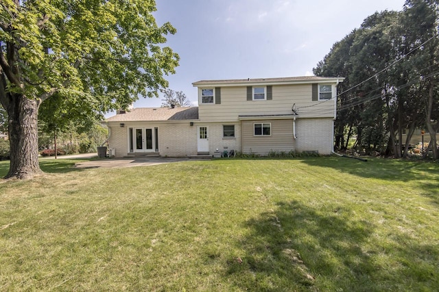 8725 N Fielding Rd, Bayside, WI 53217 - rear view of property featuring french doors, brick siding, a lawn, and a patio area