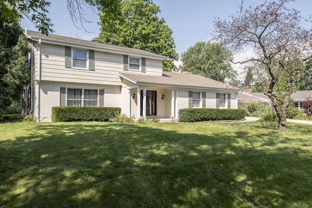 8725 N Fielding Rd, Bayside, WI 53217 - traditional-style home featuring a front yard and brick siding