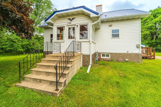 2941 Plover Rd, Wisconsin Rapids, WI 54494 - back of property featuring a yard, a metal roof, and a chimney
