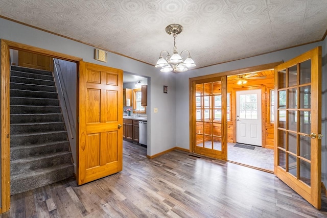 2941 Plover Rd, Wisconsin Rapids, WI 54494 - unfurnished dining area featuring light wood-type flooring, stairway, a chandelier, crown molding, and french doors