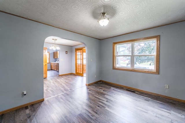 2941 Plover Rd, Wisconsin Rapids, WI 54494 - unfurnished room with arched walkways, light wood-type flooring, and ornamental molding