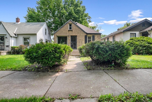 4636 N 19th St, Milwaukee, WI 53209 - bungalow-style house with brick siding and a front yard
