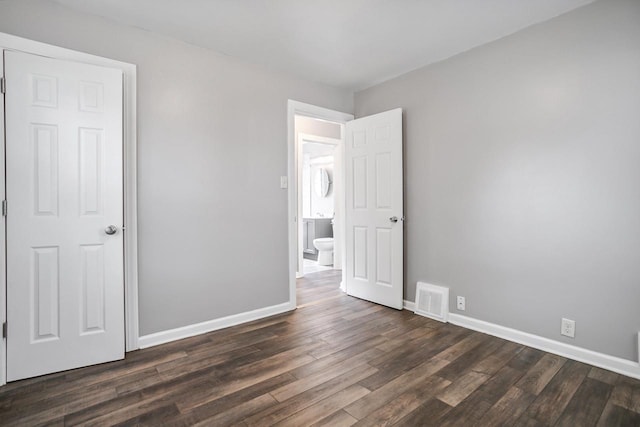 4636 N 19th St, Milwaukee, WI 53209 - unfurnished bedroom with dark wood-style flooring and baseboards