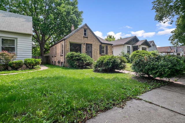 4636 N 19th St, Milwaukee, WI 53209 - view of front of house with brick siding and a front lawn