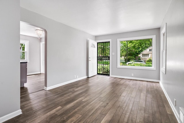 4636 N 19th St, Milwaukee, WI 53209 - unfurnished room with dark wood-type flooring, a chandelier, and arched walkways