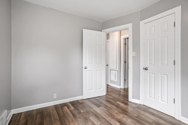 4636 N 19th St, Milwaukee, WI 53209 - unfurnished bedroom with dark wood-type flooring and baseboards