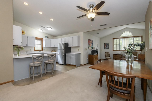 3910 S 92nd St Unit 3910, Milwaukee, WI 53228 - dining space with vaulted ceiling, a ceiling fan, plenty of natural light, light colored carpet, and recessed lighting